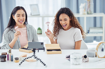 Image showing Happy influencer doing makeup review video podcast for online beauty blog or vlog using her phone at home. Female content creator or influencer live streaming her cosmetic skills for social media
