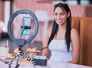 Image showing Social media influencer online video of food at cafe, smartphone technology with mobile light lifestyle vlog. Happy young girl in restaurant with film camera, woman eating fries, burger and cocktail