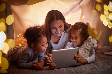 Image showing Mother and children live streaming movies on tablet or digital kids app in a tent camping at night and bokeh lights. Care, love mom reading ebook to happy girl or online games with home wifi in dark