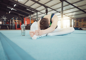 Image showing Gymnast man stretching legs at gym with flexibility fitness exercise or workout training for sports competition start. Healthy young sport athlete train for cardio, energy and body performance goal