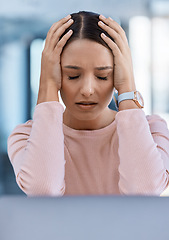 Image showing Stressed, tired and sick young woman with a headache feeling sad and overworked in an office. A frustrated, ill and unhappy female employee with a migraine suffering from pain and depression