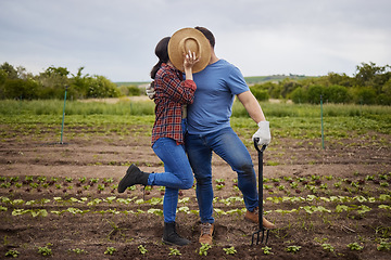 Image showing Couple kiss, agriculture farmer or garden worker on countryside field, sustainability nature or growth landscape. Bonding, romantic and fun man and woman working with environment plant and earth soil