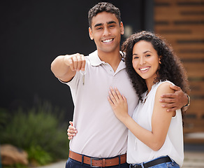 Image showing Happy couple with key to new home together, buying property as married man and woman and moving into real estate house. Portrait of people giving hug with love and homeowner excited about move