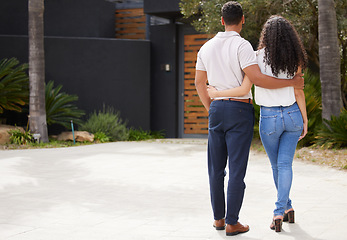 Image showing Property, real estate and new home with a man and woman homeowner looking at their house together outside. Property, real estate and an investment in their future with a couple standing on a driveway