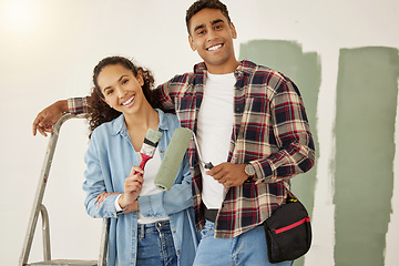 Image showing Painting, love and home with a couple doing DIY, renovation and house remodel with a paintbrush and roller. Domestic relationship and teamwork with a man and woman ready to paint a room