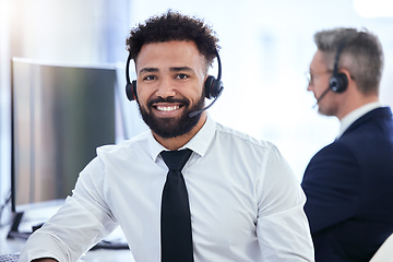 Image showing Call center, office and contact us of a businessman in customer support with happy smile in the workplace. Portrait of a telemarketing employee working in the communication business at work in tech.