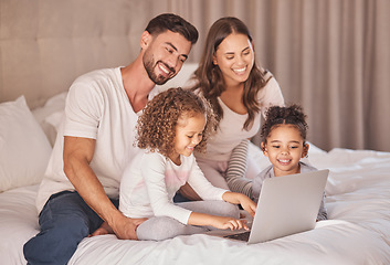 Image showing Family, laptop and relax on bed together with kids for bonding time. Caring home, parents and young daughters with happy relationship. Smiling couple and children having quality time while relaxing.