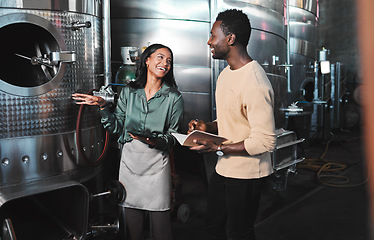 Image showing Wine business manufacturing warehouse factory, winery tank cellar brewery warehouse. Happy female winemaker employee at work b2b, ferment grape fruit storage.process and partner company meeting job
