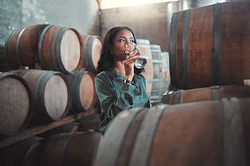 Image showing Winemaker womanwith white wine tasting glass, Chardonnay or quality alcoholic drink in winery, factory or warehouse. Entrepreneur in hospitality, winemaking industry testing flavor in cellar