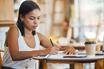 Image showing Small business owner, startup entrepreneur or cafe store manager writing notes, working on strategy or planning in a coffee shop. Professional, finance and budget businesswoman filling out papers.