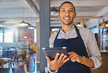 Image showing Restaurant entrepreneur with tablet, leaning on door and open to customers portrait. Owner, manager or employee of a startup fast food store, cafe or coffee shop business standing happy with a smile