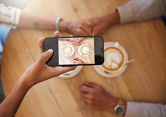 Image showing Phone influencer couple at a coffee shop taking photo of coffee on a romantic date for social media vlog. Top view POV of trendy people in love sharing anniversary or valentines day memories online