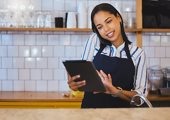 Image showing Female cafe or small business manager on phone call, reading a digital tablet in her store. Startup business woman, entrepreneur or employee working in a coffee shop preparing online grocery sales