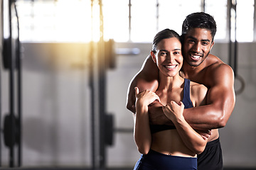 Image showing Strong, active and wellness couple looking fit and healthy after workout training session in a gym. Young sexy, attractive and athletic boyfriend and girlfriend hugging after reaching fitness goal