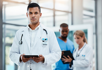 Image showing Doctor or surgeon working with electronic documents on digital tablet, standing in hospital hallway or foyer. Healthcare professional doing virtual consultation online or using medical software app.