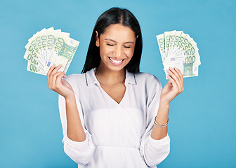Image showing Money, winner and cash in hands of a woman cheering wealth and success in celebration with a wow in studio on blue background. Rich, celebrating and excitement with a happy female winning the lottery