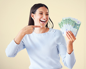 Image showing . Money, investment growth and finance success of a happy, excited and smiling woman pointing at cash reward. Lucky and happy female showing her growing financial wealth, savings or bank loan payout.