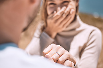 Image showing Engagement, proposal and romance wth a man asking his fiance to marry him while dating and spending time together. Closeup of a ring on the finger of a woman who just say yes to a marriage proposing