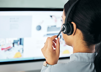 Image showing Call center agent giving online support with computer screen, working as advisor and doing telemarketing in an office at work from behind. Closeup of customer service representative talking with pc