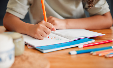 Image showing Child coloring, drawing and doing art activity in book in home living room while having fun, enjoying and feeling playful. Closeup hands of small, little and young creative girl expressing with color