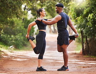 Image showing Young fit couple exercising outdoors together, bonding while stretching and preparing for a cardio workout. Athletic girlfriend and boyfriend being affectionate while training and staying healthy