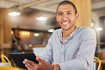 Image showing Freelancer entrepreneur or designer working online holding digital tablet, sitting in cafe or restaurant. Successful businessman with flexible schedule doing remote work on internet in coffee shop.