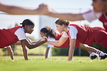 Image showing Women soccer, football or team sports holding hands in unity, support or motivation in routine workout, exercise or training drill. Diverse group of fit, active or healthy athletes and girls on field