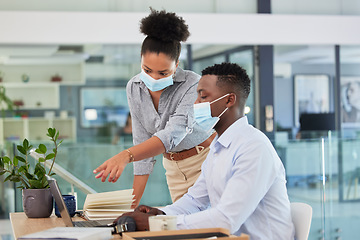 Image showing Covid, masks and safety in the workplace of business people working together during a pandemic in an office. Manager, trainer or mentor training businessman how to use software on laptop.