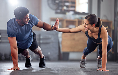 Image showing Fitness, motivation and high five while doing push ups and exercising together at the gym. Healthy, fit and athletic couple goals while enjoying a training session with teamwork at a health club