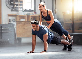 Image showing Fitness, strong and wellness couple exercising, training or workout exercise inside gym. Sporty professional woman and man or trainer doing pushup and balance in a physical endurance session
