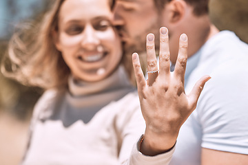 Image showing Closeup hand of proposal engagement ring after romantic, caring and loving man proposes to woman. Happy, smiling and excited couple showing wedding band while hugging, embracing or holding each other