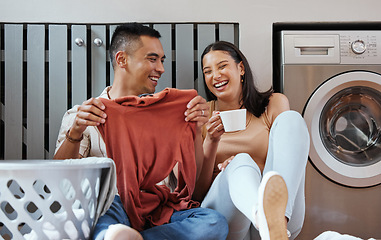 Image showing Carefree and funny couple doing laundry and relaxing together at home in the morning. Silly, goofy and playful lovers laughing and giggling while cleaning the washing, and doing house chores