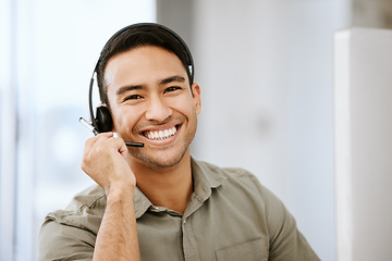 Image showing Smiling, friendly call center agent with headset for online consulting in an IT tech agency. Face of male ecommerce support professional offering virtual assistance to web user or contact us hotline
