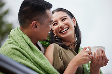 Image showing Cozy, smiling and romantic young couple cuddling and relaxing with blanket in cold winter. Loving husband and wife laughing and enjoying dating relationship bonding time in outdoors nature