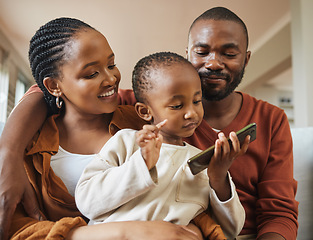 Image showing Happy, bonding and family time with a black family on a video call. Young parents being affectionate with their baby while streaming and watching something on a phone, enjoying time with their son