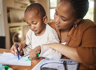 Image showing African mother and small child drawing together at a desk at home. Caring, working woman making family time to play with kid. Fun and educational activities for loving mom and artistic young son.