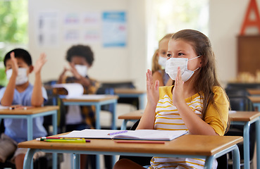Image showing Safety, compliance and education in classroom at school with students wearing masks during corona pandemic. Young learners clapping, excited and attentive during and educational lesson on hygiene
