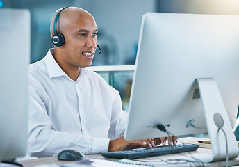 Image showing Professional, friendly customer service or sales consultant agency worker working with headset and desktop. Smiling male employee consulting with a client at call center or contact us helpdesk