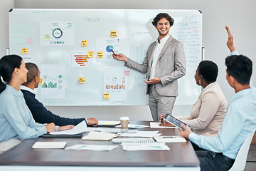 Image showing Business coach presenting marketing or financial budget report and accounting statistics or sales charts on white board. Leader and mentor discussing company growth strategy with diverse colleagues.