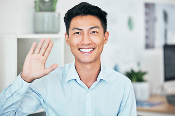 Image showing Happy business man greeting, waving and saying hello with hand gesture while smiling and looking friendly in an office. Portrait of asian entrepreneur saying thank you or welcome during testimonial