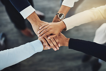 Image showing Hands stacked or piled to show team unity, strength or motivation among business men, women or colleagues from above. Closeup of huddled, motivated group of businesspeople in support and trust circle