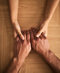 Image showing Man and woman holding hands sharing feelings of love, support and trust together on a table. Closeup of a loving couple expressing care, promise and compassion to overcome problems