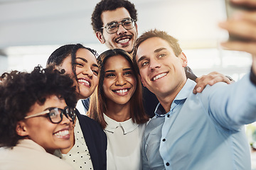 Image showing Happy, diverse and carefree colleagues taking a selfie to share on social media on their break. An excited young group of employees having fun at the office taking a picture or photo