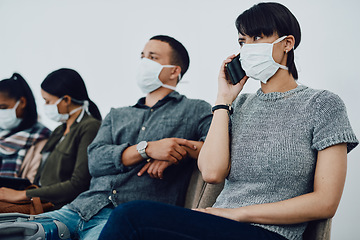 Image showing Woman calling while traveling with covid and waiting in line at airport while wearing a mask for protection. For hygiene and healthcare security, follow coronavirus social distance regulations