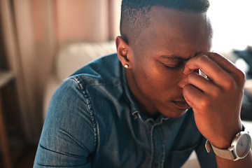 Image showing Stressed, tired businessman with headache alone at home. Man having eye tension or strain from overworking, burnout and anxiety. Depressed male having problems at work, suffering from lack of sleep.