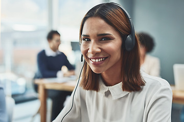 Image showing Customer service, IT support or call center agent helping and assisting on a call using a headset. Portrait of a young female sales assistant or secretary smiling while working in a modern office