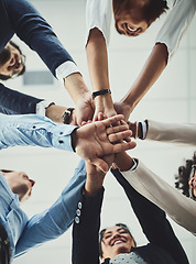 Image showing Teamwork, collaboration and unity between business people with their hands stacked for project development and innovation. Group of corporate colleagues united, joining or working together from below