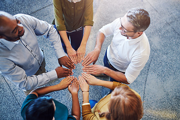 Image showing Fun, collaboration and teamwork in hands linking during team building by diverse group of business people. Above happy investors showing support, trust and motivation while huddling, joining together