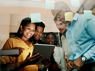 Image showing Group of creative, excited and smiling design team, working, researching and browsing on tablet for innovation ideas in modern office. Office workers planning a group work project after hours.