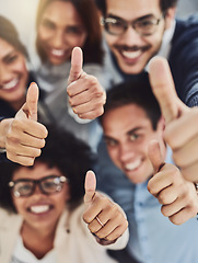 Image showing Thumbs up from a happy business team excited about the success they achieve together at work. Overhead view diverse group of corporate people excited by success and give approval to winning